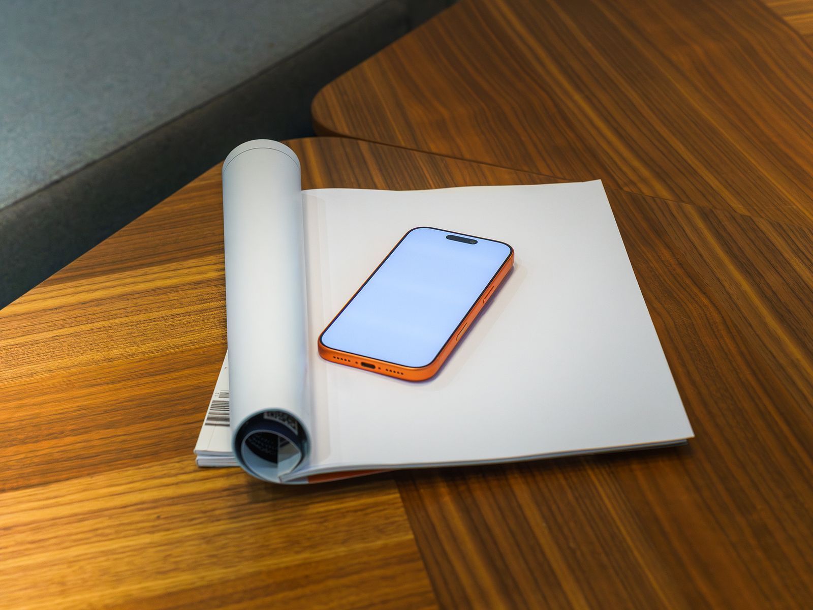 A phone in a leather case resting on an open notebook